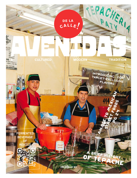 Magazine cover featuring two people in a kitchen with 'De La Calle' branding.