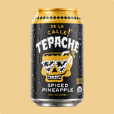 A 12 fl oz can of Tepache Spiced Pineapple soda, featuring a black label with a gold skull wearing sunglasses and white lettering, set against a solid beige background.
