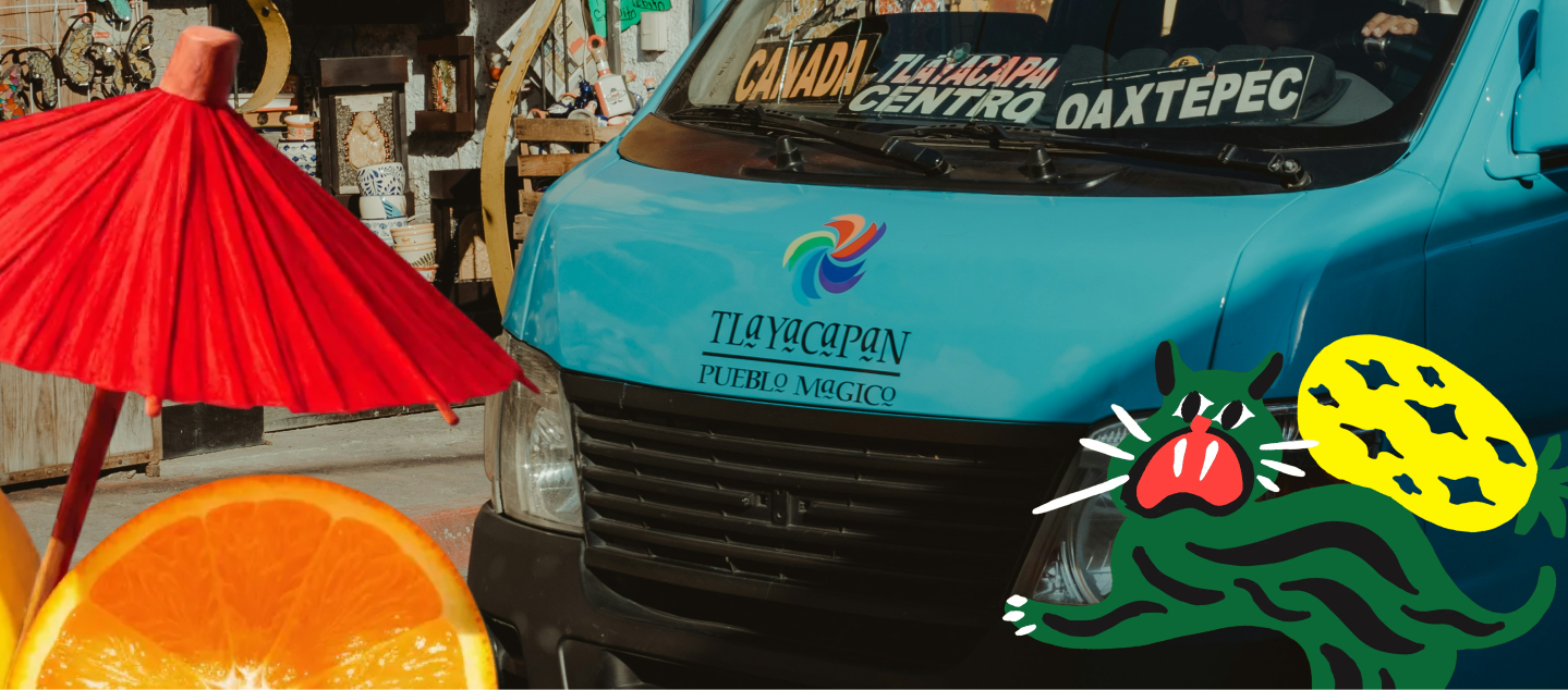 Blue van with colorful graphics and text, surrounded by a red umbrella and orange fruit.