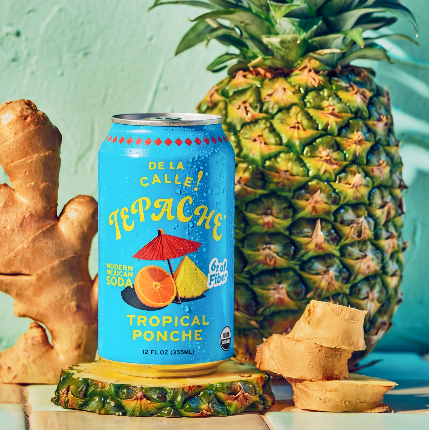 Can of Tepache tropical ponche with a pineapple, ginger root, and a light blue background