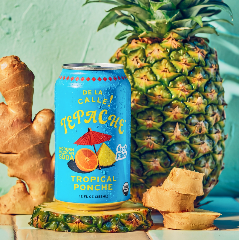 Can of Tepache tropical ponche with a pineapple, ginger root, and a light blue background